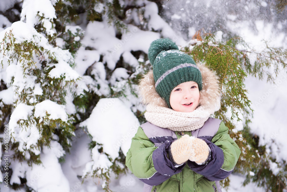Little boy play with snow in the park. Christmas mood Little boy play with snow in the park. Christmas mood