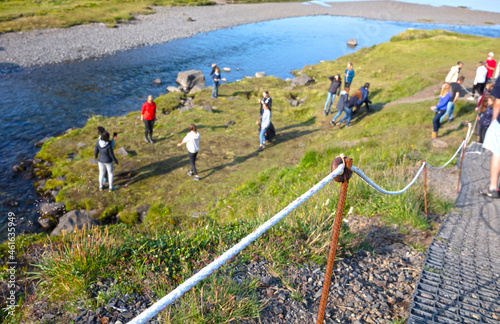 Kirkjufell, Iceland on August 7, 2021 - Foreign tourists ignoring the boundaries set by the Icelandic people, crossing lines and meanwhile destorying nature photo