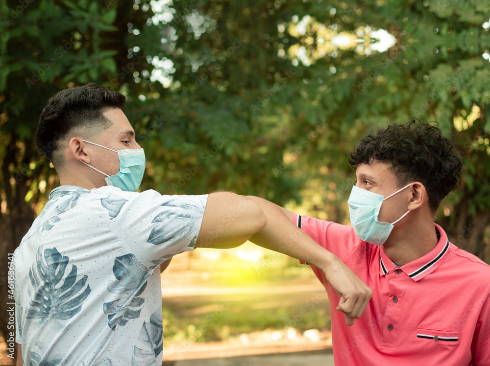 Two young people bumping their elbows, image of two young people bumping their elbows in a friendly way, about two elbows bumping in a friendly way Two young people bumping their elbows, image of two young people bumping their elbows in a friendly way, about two elbows bumping in a friendly way