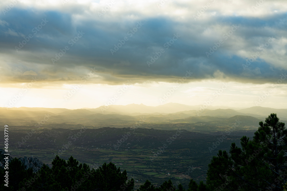 View from above, stunning view of a grasslands surrounded by a mountain range during a beautiful sunrise. Panoramic view from Monte Pino, (Vedetta Monte Pino) Sardinia, Italy. View from above, stunning view of a grasslands surrounded by a mountain range during a beautiful sunrise. Panoramic view from Monte Pino, (Vedetta Monte Pino) Sardinia, Italy.