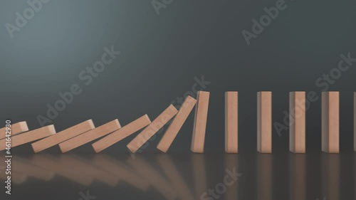 close-up view of falling domino wooden blocks on reflective background, copy space (3d render) photo