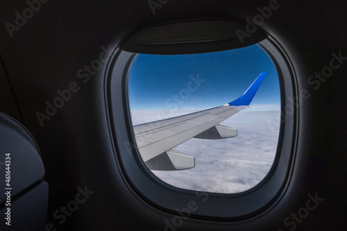 aircraft wing from the aircraft window overlooking the blue sky and beautiful clouds