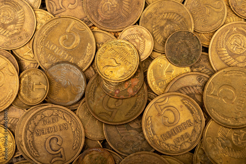 Old coins out of circulation in bulk, background image, close-up, selective focus.