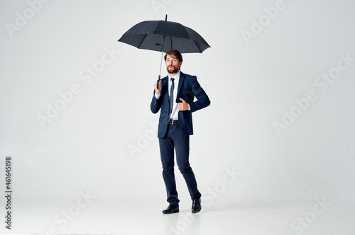 business man in a suit umbrella overhead protection
