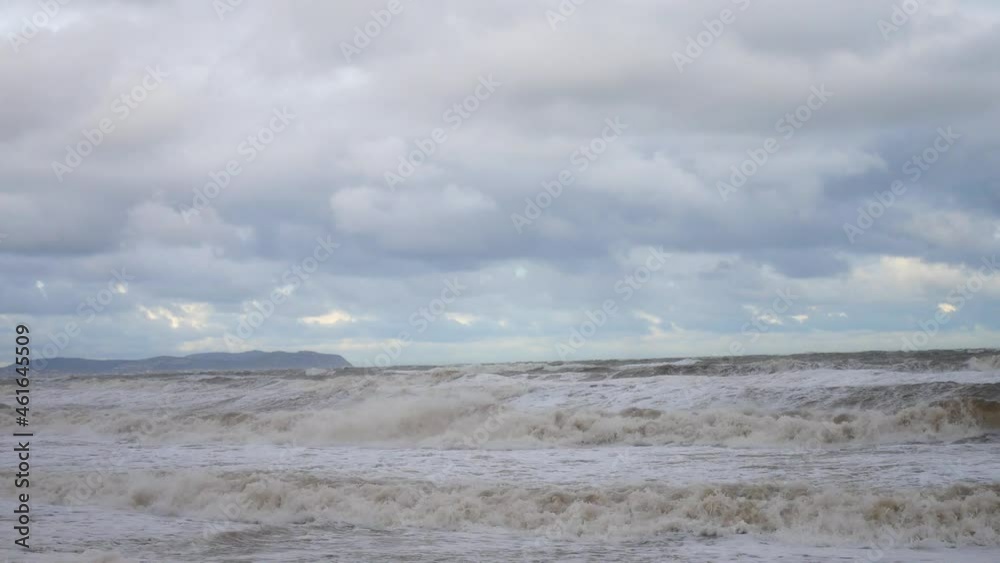 Menacing stormy rolling coastal ocean waves blowing in rough windy weather storm Sam Menacing stormy rolling coastal ocean waves blowing in rough windy weather storm Sam