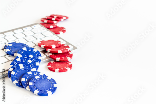 Gambling chips on keyboard. Online poker casino concept. Top view