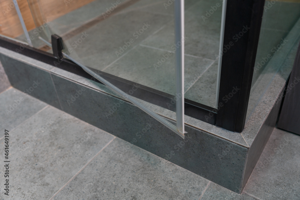 Open revolving glass door on a tiled shower cubicle Stock Photo | Adobe Stock