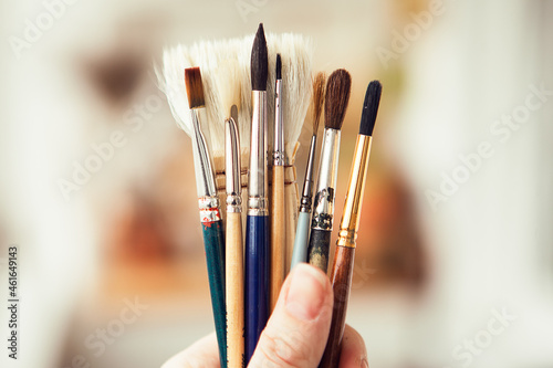 Set with paint brushes. Different paint brushes in somebody's hand