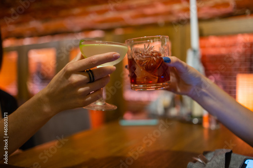 Clinking glasses with alcohol and toasting, party.