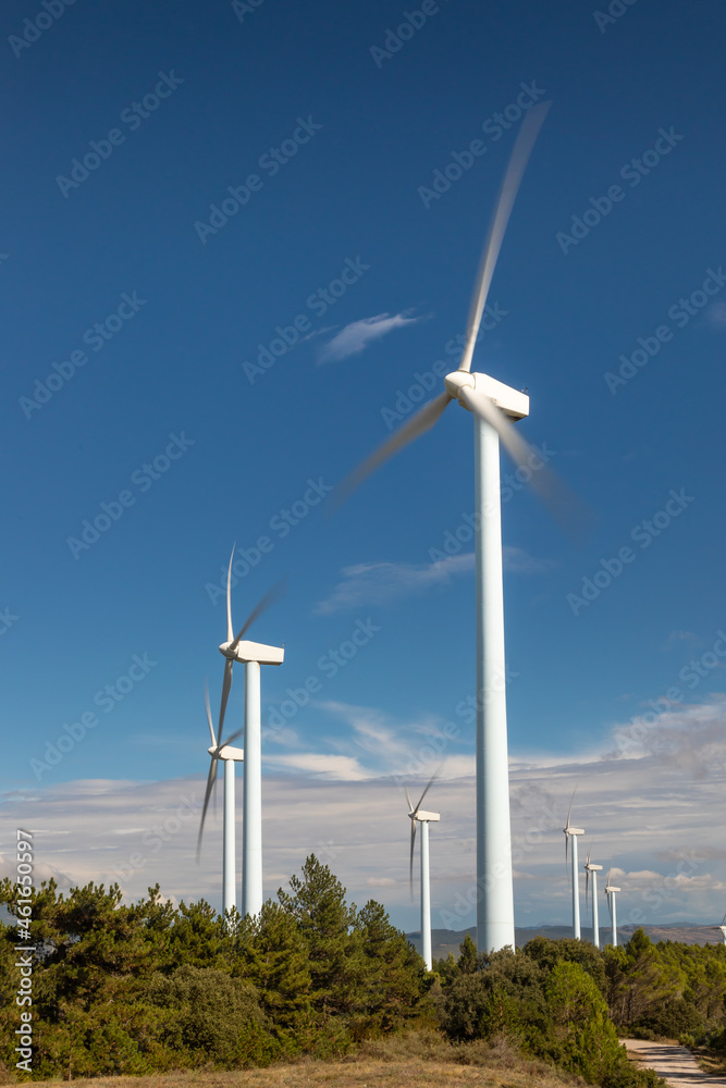 Wind farm, modern windmills on a bright and sunny day Wind farm, modern windmills on a bright and sunny day