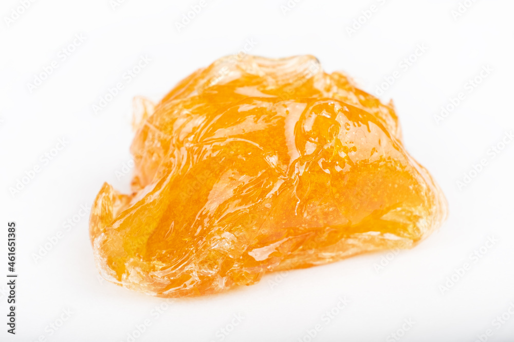 yellow wax piece with high THC isolated on white background. yellow wax piece with high THC isolated on white background.