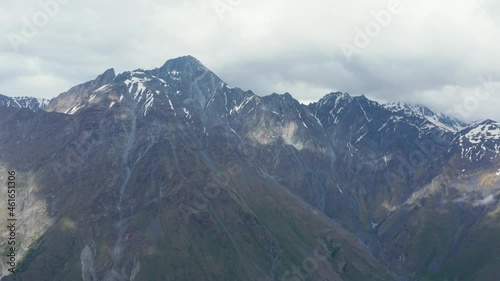 Wallpaper Mural Stunning aerial panoramic view of mountain range. Bright day, sky covered with clouds, casting shadows on slopes. Slight backwards movement. 4k footage. Torontodigital.ca