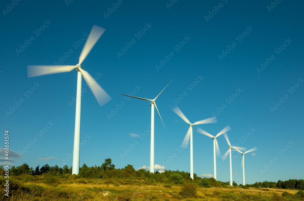 Wind farm, modern windmills on a bright and sunny day Wind farm, modern windmills on a bright and sunny day