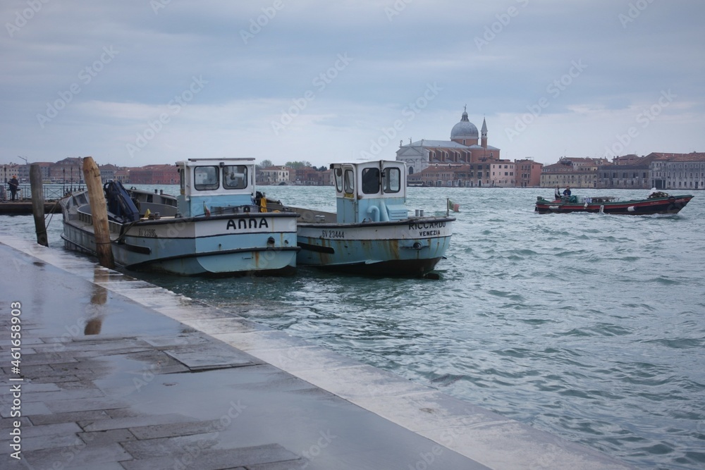 Venetian memorable views of Grand сanal - windy promenade with fishing boats.