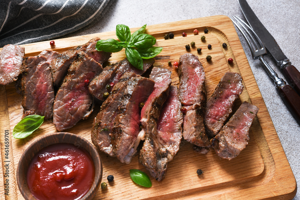Rare beef steak, slice on wood board. View from above. Rare beef steak, slice on wood board. View from above.