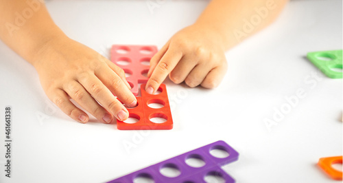 child learning counting playing with numicon photo