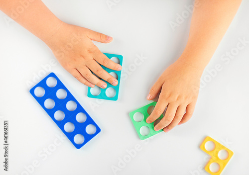 child learning counting playing with numicon photo