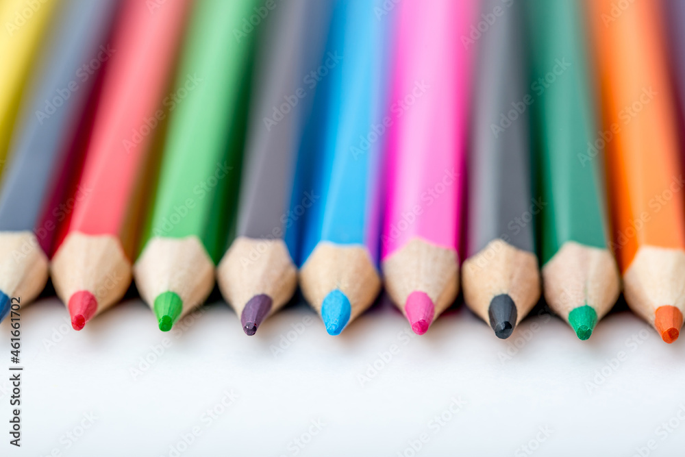 School stationery items. Creation Multicolored pencils on a blank white sheet. On a white background. Children's drawing, artist. School stationery items. Creation Multicolored pencils on a blank white sheet. On a white background. Children's drawing, artist.