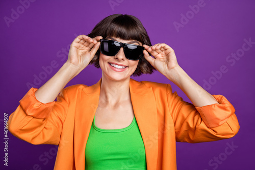 Photo of sweet millennial brunette lady wear orange blazer top eyewear isolated on violet color background