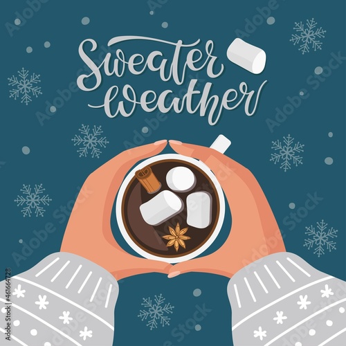 Sweater Weather calligraphy lettering and hot chocolate or coffee cup with marshmallow, cinnamon and anise. Two human hands holding cup of hot drink. Vector illustration in flat styleon dark blue
