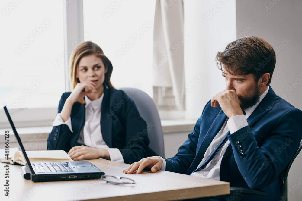 colleagues in the office in front of a laptop career work professionals colleagues in the office in front of a laptop career work professionals