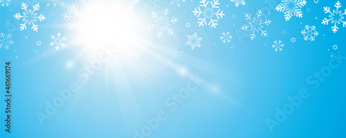 sunny winte sky background with snowflakes and copy space