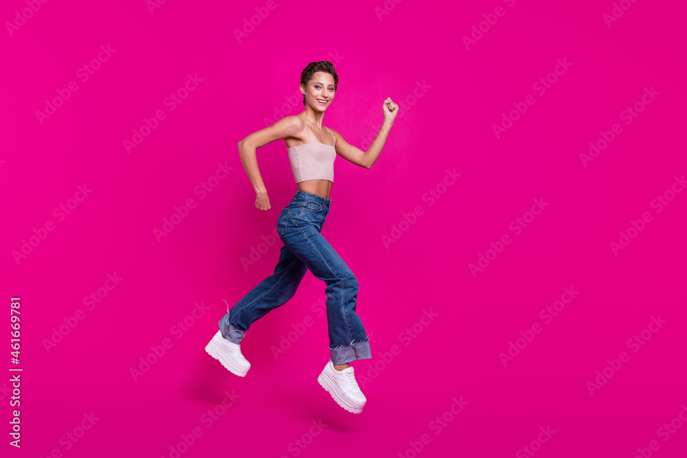 Full length profile side photo of happy attractive woman jump runner empty space sale isolated on magenta color background