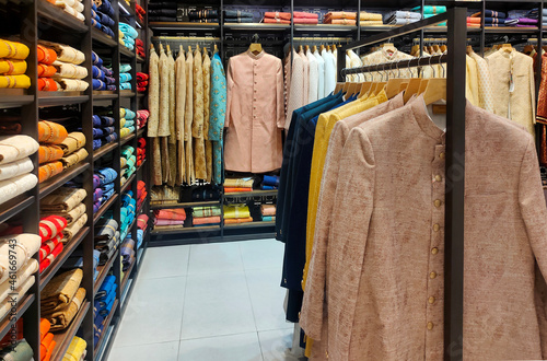 Photography Pune ,INDIA, 2 October 2021 : Indian men latest fashion dress hung on hangers, i