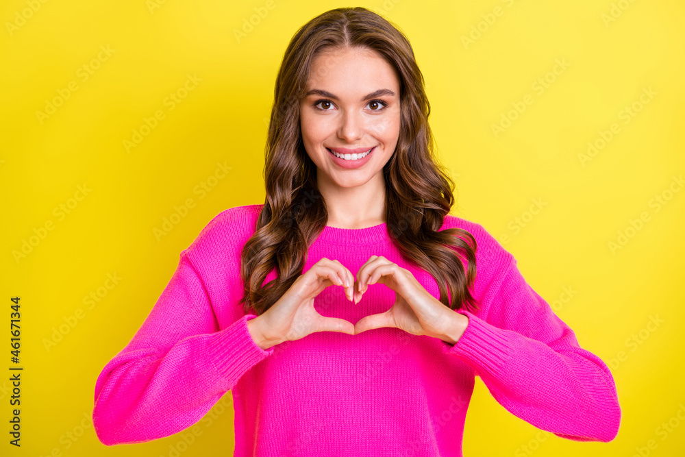 Photo of flirty charming wavy young woman wear pink sweater showing fingers heart isolated yellow color background Photo of flirty charming wavy young woman wear pink sweater showing fingers heart isolated yellow color background