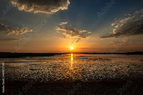 Valokuva Pagham Harbour nature reserve sunset at low tide.
