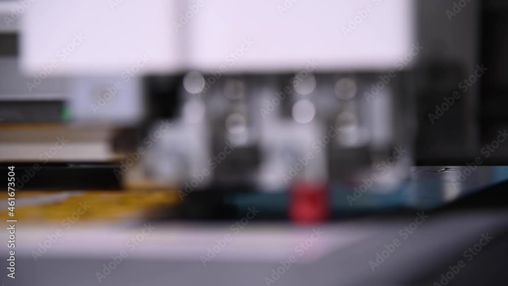 Industrial A close-up of an industrial plotter cuts a template on a cardboard packaging for products. real time shallow depth of field. Live camera Industrial A close-up of an industrial plotter cuts a template on a cardboard packaging for products. real time shallow depth of field. Live camera