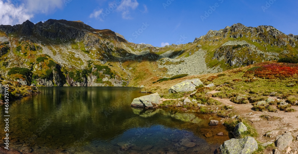 amazing different colors at a mountain lake in the summer panorama