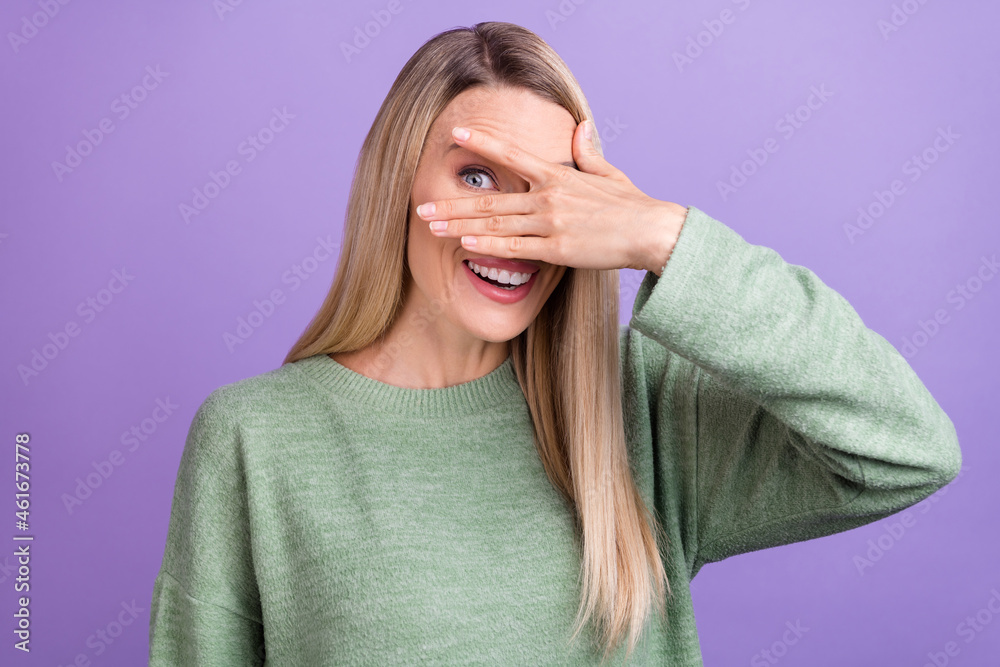 Photo of young cheerful girl have fun good mood play cover eye look see isolated over purple color background