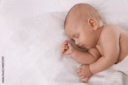 Cute little baby sleeping in bed, top view. Space for text