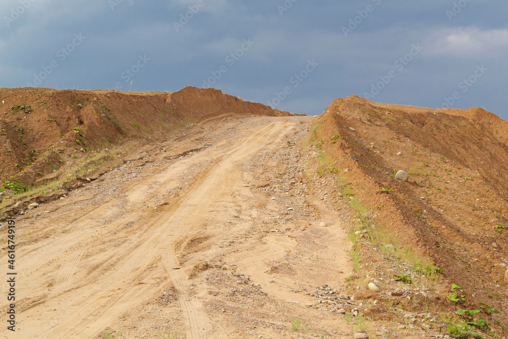 heap in the quarry sand against the blue sky. Belarus