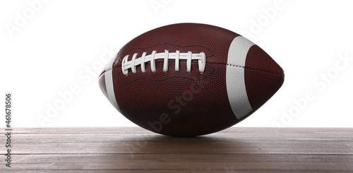 American football ball on wooden table against white background