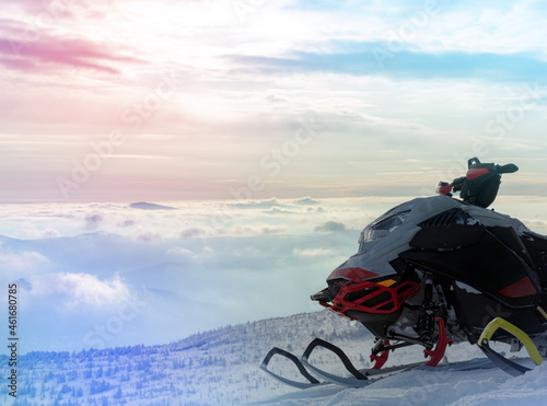 two professional sports snowmobiles on the top of the mountain in the morning without a rider. the concept of advertising recreation and travel on snow bikes. high quality photos