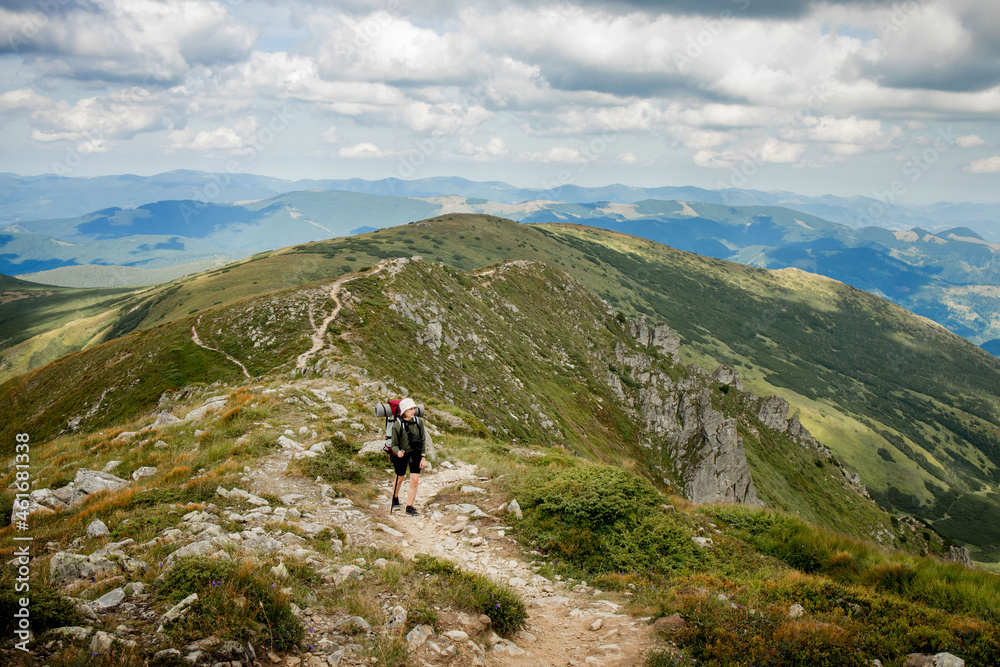 Hiker on the top in Carpathians mountains. Travel sport lifestyle concept.