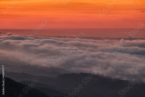 Clouds descend over Playa de la Isla at sunset. Asturias. Spain © JaviJfotografo