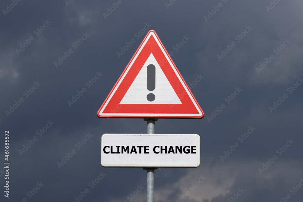 A sign with a exclamation mark warning for a dangerous situation ahead and a smaller sign below with the English text Climate Change on it A sign with a exclamation mark warning for a dangerous situation ahead and a smaller sign below with the English text Climate Change on it