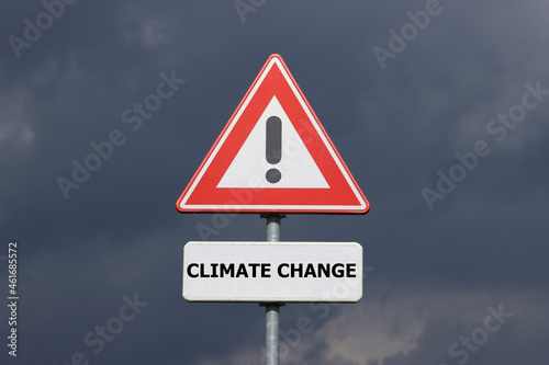 A sign with a exclamation mark warning for a dangerous situation ahead and a smaller sign below with the English text Climate Change on it
