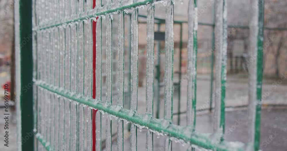 Frozen city environment in the ice icicles. Climatic icing. Slow motion footage of a winter iced frozen city space. Icy city cage after winter natural disaster. City environment in a winter. Frozen city environment in the ice icicles. Climatic icing. Slow motion footage of a winter iced frozen city space. Icy city cage after winter natural disaster. City environment in a winter.