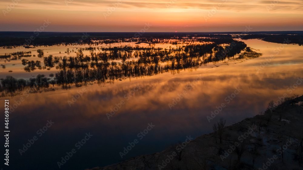 Aerial atmospheric view on big river. Aerial drone view of river landscape in sunny sunset. Nature concept.