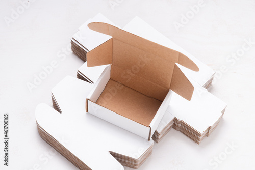 Lot of unfolded cardboard boxes ov wooden desk
