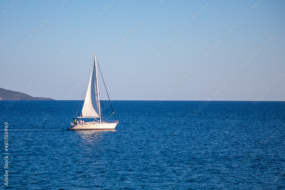 View of small yacht boat sailing in calm open sea in Montenegro 