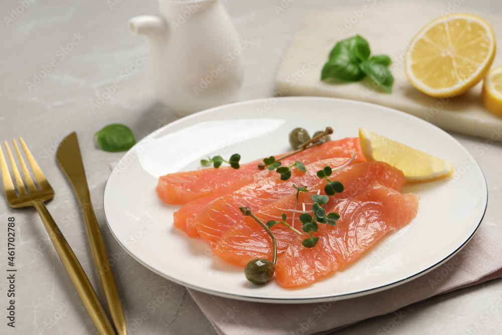 Delicious salmon carpaccio served on light grey table, closeup