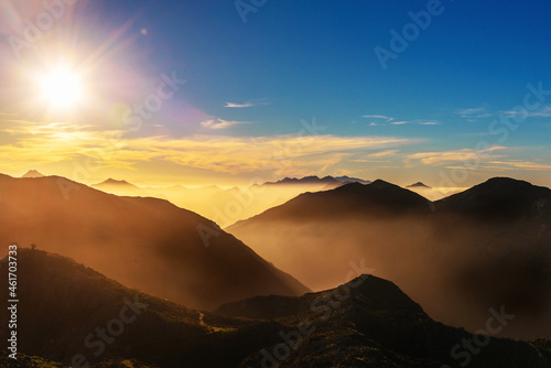 mountain landscape with haze at sunset. Mountain ranges of 