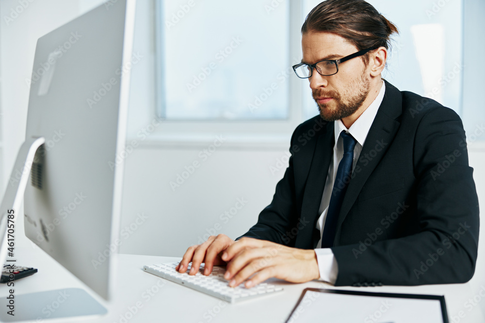 male manager an official is working at the computer Chief