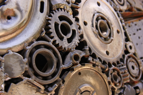 Detail of metal gears and wheels and metallic parts welded together, industrial background