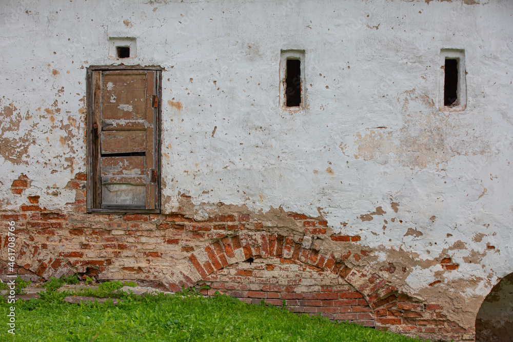 Strange old unusable door mounted in the old brick wall.